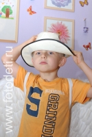 Прикольный малыш в белой шляпе, фото сделано на детском празднике